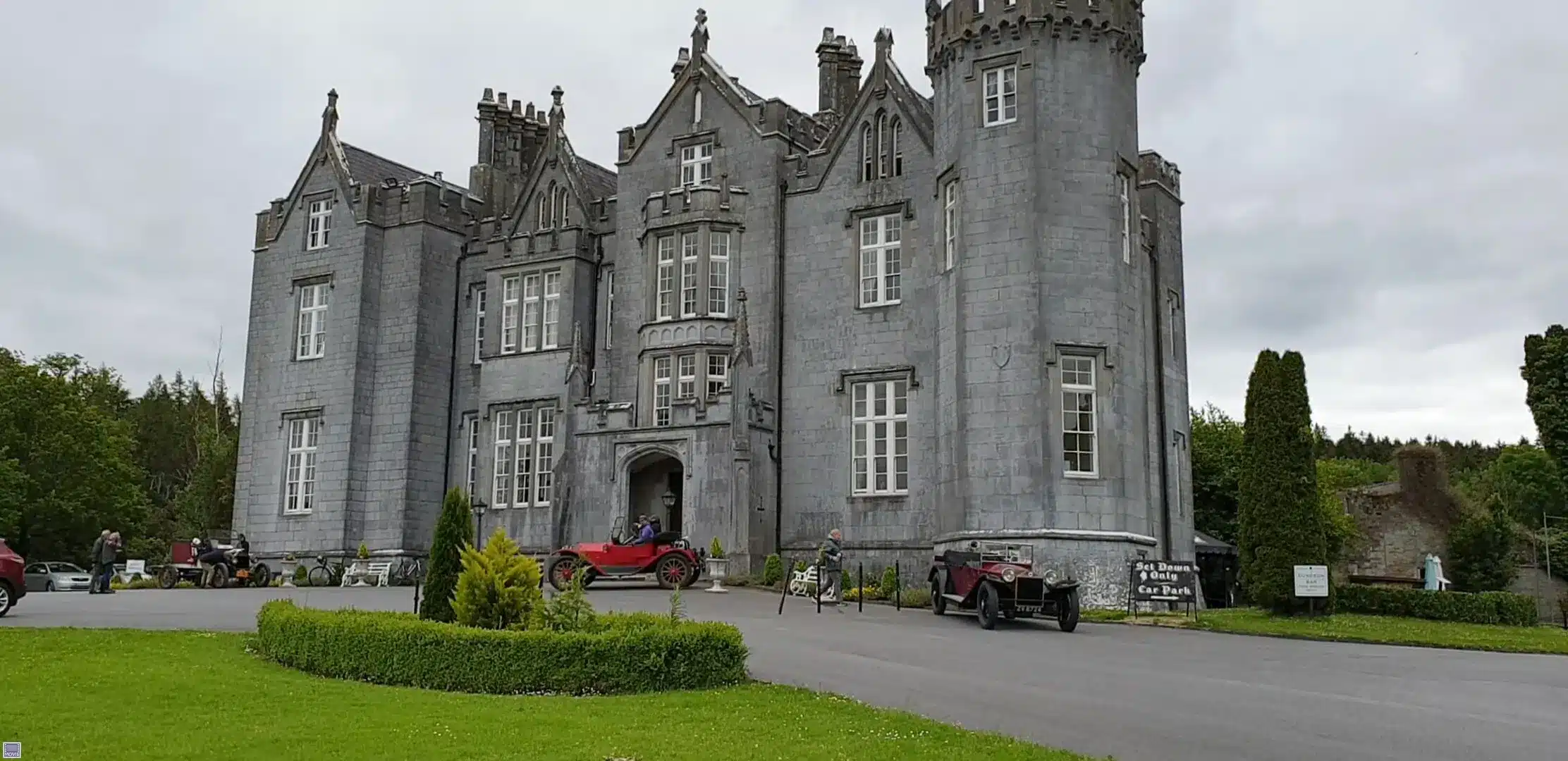 A historic castle with a gray stone facade and intricate architecture