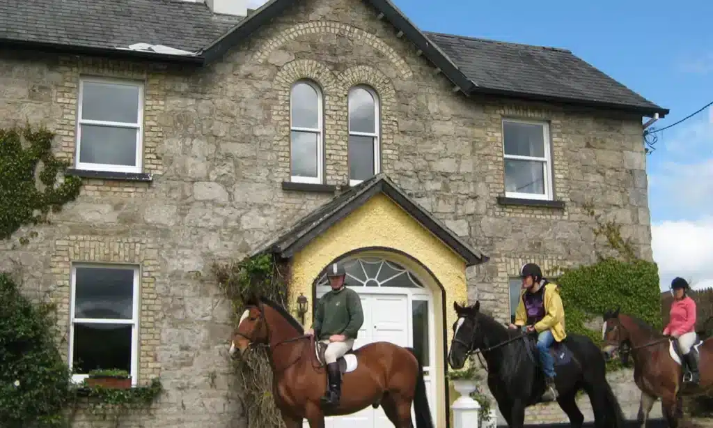 Horse riders in the picturesque countryside, with a charming stone house near Ardmore Country House